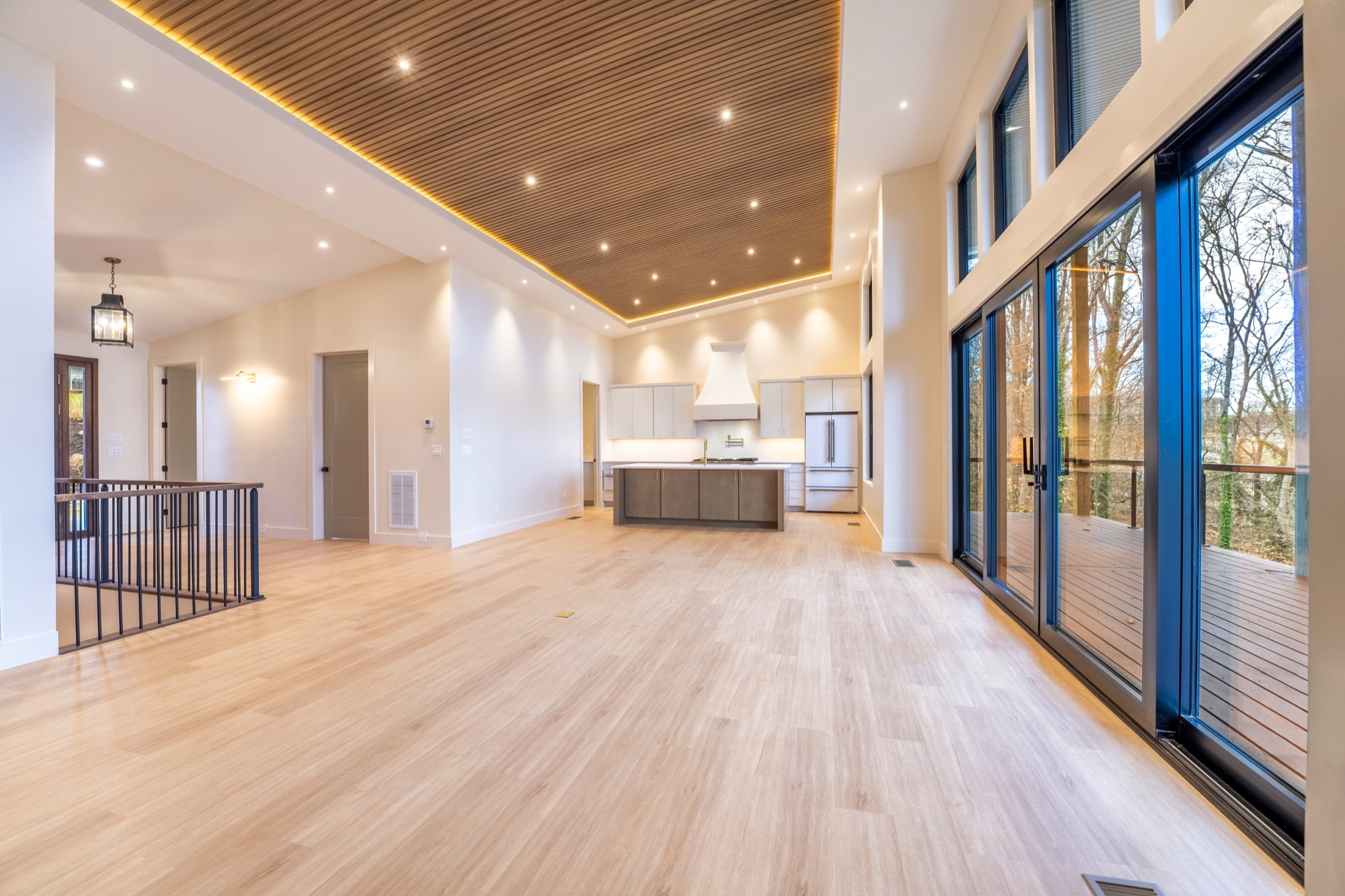 Completed custom home great room with vaulted ceiling and wooded views in East Tennessee